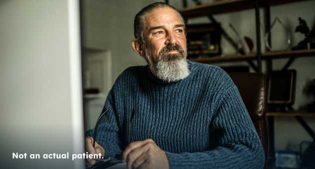 Older-man-sitting-with-gaze-directed-away-from-camera