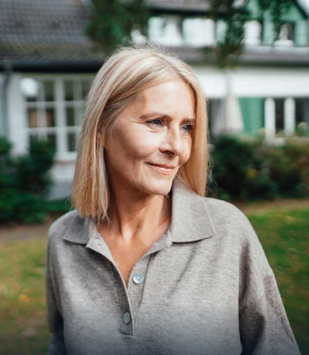 Middle-aged woman smiling looking away from camera